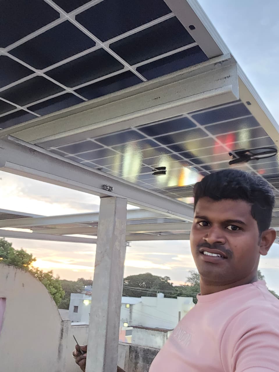 Solar panel installation with technician on rooftop