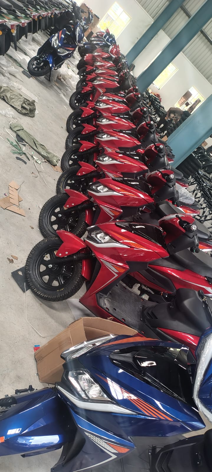 Large inventory of red and blue electric scooters
