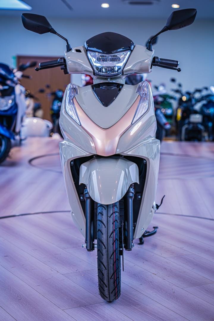 Cream electric scooter in modern showroom