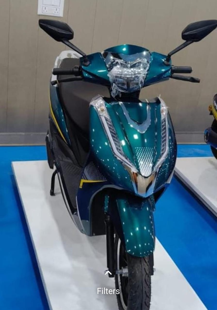 Teal electric scooter on display platform